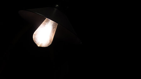 lamp on a black background, close-up, light bulbの写真素材