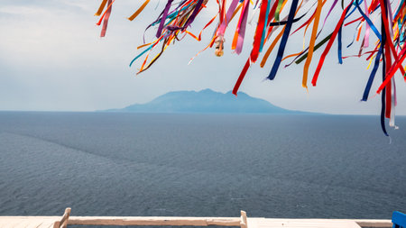 Colorful traditional wish ribbons tied to an iron pole tree in Kalekoy, Gokceada. Many multi-colored ribbons fluttering in the wind.の写真素材