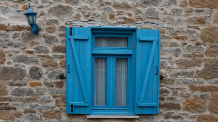 Blue wooden window on a stone wall in the old town of Rovinj, Croatiaの写真素材