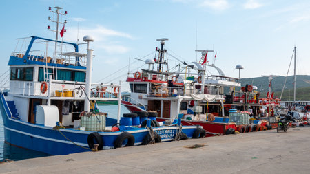 GÃ¶kÃ§eada, Ãanakkale, Turkey May 27, 2023 Kalekoy Harbor with moored swordfish ships at sunset. Kalekoy is the oldest port of Gokceada.のeditorial素材