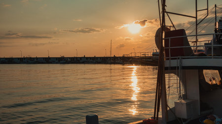 KalekÃ¶y village harbor on GÃ¶kÃ§eada island with docked boats at sunsetの写真素材