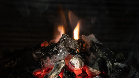 Burning coals in the fireplace close-up. abstract background