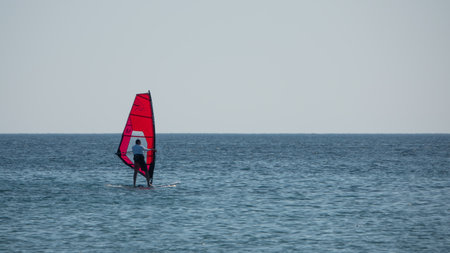 Gokceada, Canakkale Turkey July 29, 2023; Wind surfers enjoying the Aegean sea and the wind in Gokceada Kefalos bay against the clear sky. Imbros Island.のeditorial素材