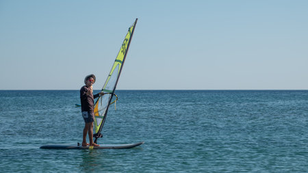 Gokceada, Canakkale Turkey July 29, 2023; Wind surfer enjoying the Aegean sea and the wind in Gokceada Kefalos bay against the clear sky. Imbros Island.のeditorial素材