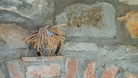 Old rustic wall made of red bricks with rope hanging on a hookの写真素材