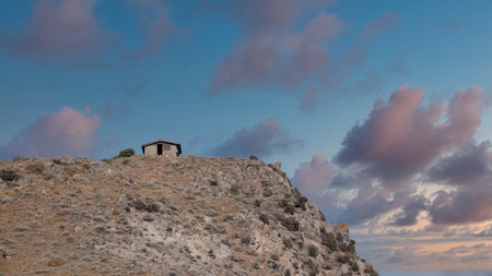 Old house on the hill at sunset, Gokceada, Turkey.の写真素材