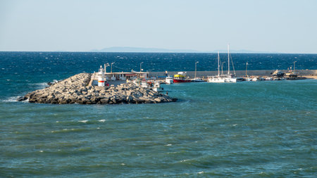 Gokceada, Canakkale, Turkey August 18,2023: Fishing and touristic excursion boats anchored in Kalekoy harbor on a windy dayのeditorial素材