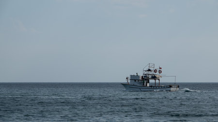Gokceada, Canakkale, Turkey septtember 12, 2023: A fishing boat returning from the sea in the...