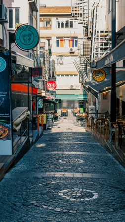 Kadikoy, Istanbul, Turkey - October 10, 2023: Street view and old style buildings, caffee shops and bars in narrow streets of Kadikoy during early in the morning.