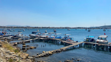 Sigacik, Izmir, Turkey Sep. 6, 2023: Fishing boats anchored around the wooden pier in Sack bay. Sack is the historical and touristic port of zmir Seferihisar.のeditorial素材