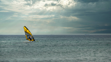 Gokceada, Canakkale Turkey September 9, 2023; Wind surfer enjoying the Aegean sea and the wind in Gokceada Kefalos bay against the clear sky. Imbros Island.のeditorial素材