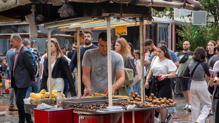 Taksim, Istanbul, Turkey - Sep.20, 2023: Seller of roasted chestnuts and corn on the Istiklal street in Istanbul. Turkish street foods are very popular in Istiklal Avenue in Taksimのeditorial素材