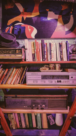 Kadikoy, Istanbul, Turkey October 14, 2022 Close-up of a vintage Grundig amplifier with Bookshelf. Vintage bookshelf with old vinyl records in retro style.のeditorial素材