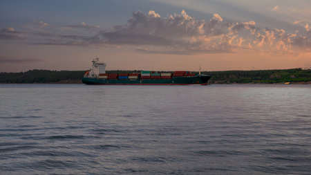Canakkale, Turkey, November 12,2023:Cargo ship on the Dardanelles strait against evening sunset sky....