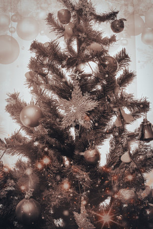 Vintage Christmas tree with ornaments and snowflakes in Sephia tone. Christmas and new year concept. Filtered image processed vintage effect.の写真素材