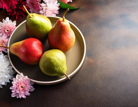 Ripe juicy pears on a plate with flowers on a brown backgroundの素材