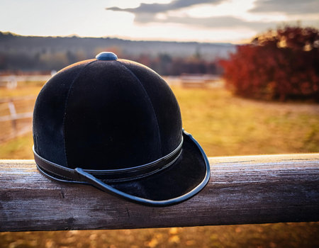 Baseball cap on a wooden fence in an autumn field at sunsetの素材