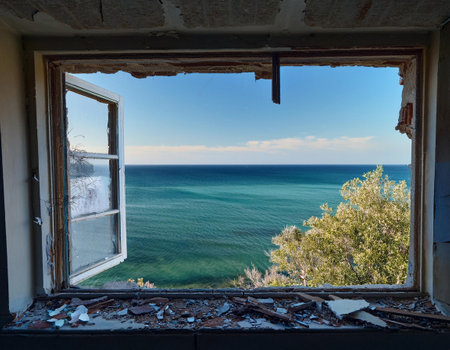 View from the window of an abandoned building on the sea and skyの素材