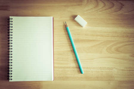Notebook  on wooden background. Vintage effect style.の写真素材