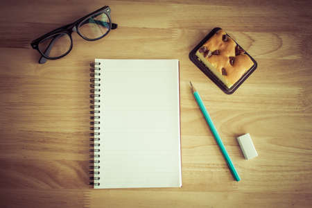 Notebook  on wooden background. Vintage effect style.の写真素材