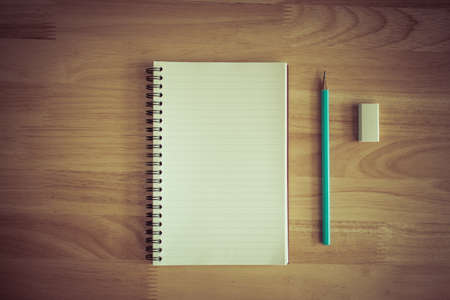 Notebook  on wooden background. Vintage effect style.の写真素材