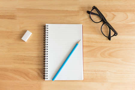 Notebook  on wooden background.の写真素材