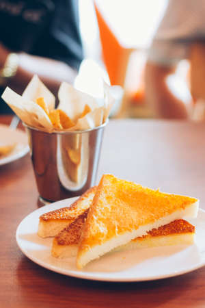 crispy toasts and french fries on wooden table