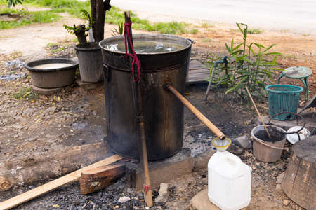 Alcohol distillation process in Laos. Alcoholic beverage made from rice.