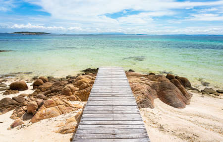 Wooden bridge to the sea with a beautiful sea at Koh Munnork, Rayong,  Thailandの写真素材