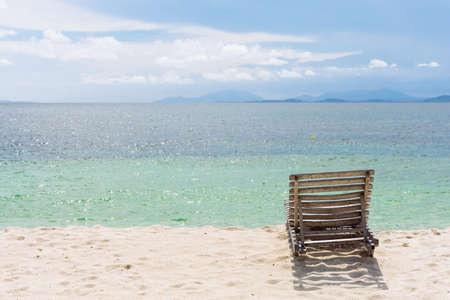 Wooden beach chair on white sand beach in Thailand.の写真素材