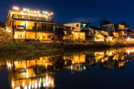 Kanchanaburi, Thailand - November 20, 2020 : E-Tong village at twilight reflection in the water.のeditorial素材