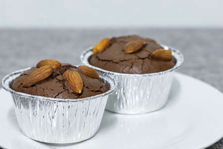 Homemade chocolate brownie cupcake with almonds. Selective focus.