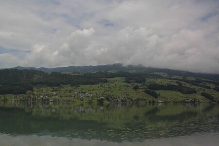 View of foggy mountains and grassの写真素材