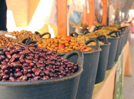 Different olives are sold on a marketの写真素材