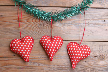 Red and white heart toys on a wooden tableの写真素材