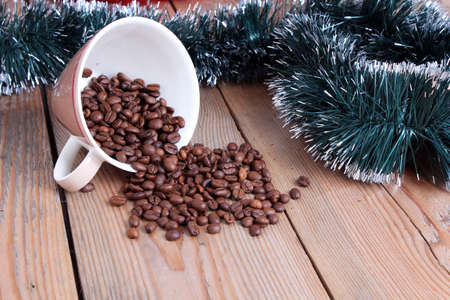 Coffee cup and beans on a wooden tableの写真素材