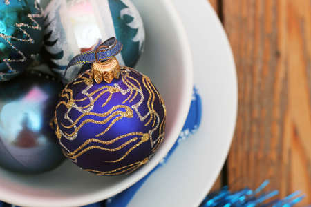 Christmas decorations with balls, white plates and blue napkinの写真素材