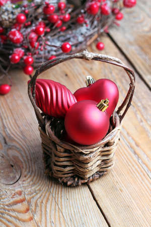 Christmas decorations with balls, brown basket and a ribbonの写真素材