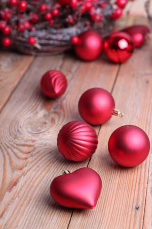 Christmas decorations with balls and a ribbon on a wooden tableの写真素材