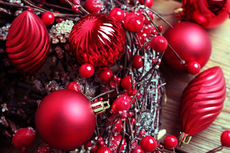 Christmas decorations with balls a ribbon on a wooden tableの写真素材