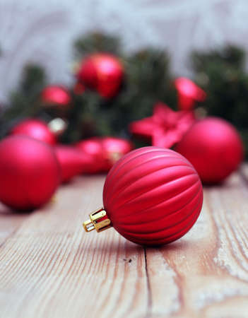 Red ball on a wooden table with christmas background. Selective focusの写真素材