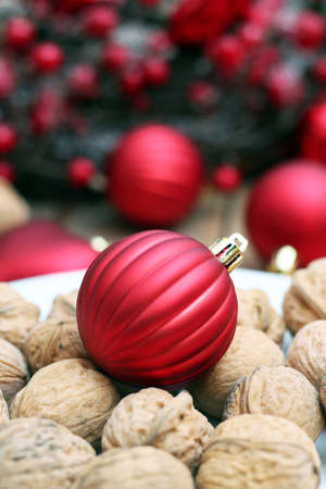 Plate with christmas ball and walnuts with christmas background. Selective focusの写真素材