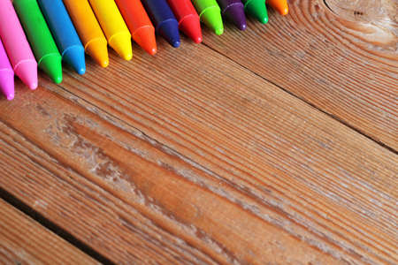 Oil pastel crayons lying on a wooden table. Selective focus. Copy space backgroundの写真素材