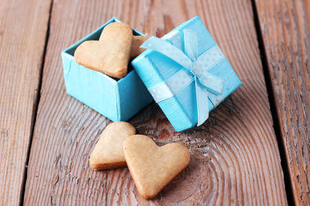 Heart shaped cookies in a blue gift box on a wooden background. Selective focusの写真素材