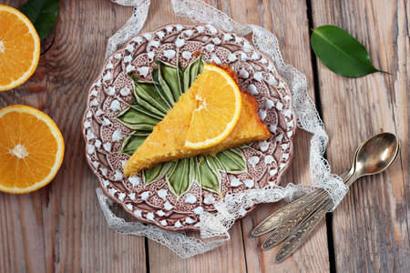 Polenta and lemon butter cake on a vintage plate on a wooden table. Selective focus, top viewの写真素材