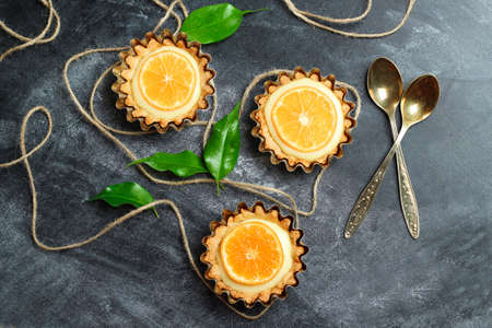 Hand made tart, tartlet with lemon curd on a black background. Selective focus, top viewの写真素材