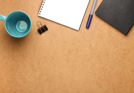 Still life, business, education concept. Office supplies, notepad, mug, clip and a pen on a table....