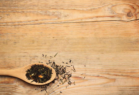 Still life, food and drink concept. Tea in a spoon on a wooden table. Selective focus, copy space background, top viewの写真素材