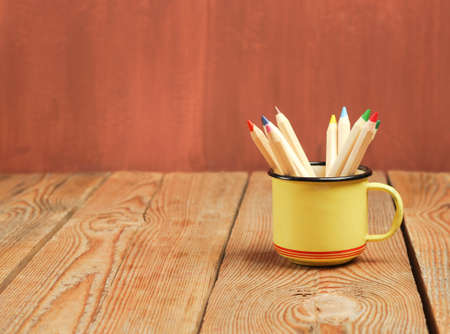 Still life, business, education concept. Pencils in a mug on a wooden table. Selective focus, copy space backgroundの写真素材