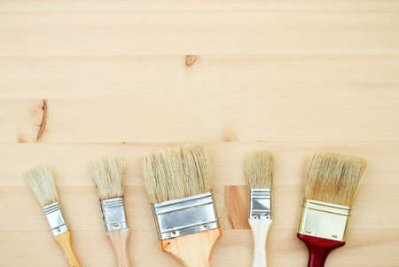 Still life, house and garden concept. Paint brushes on a wooden background. Selective focus, copy space background, top viewの写真素材